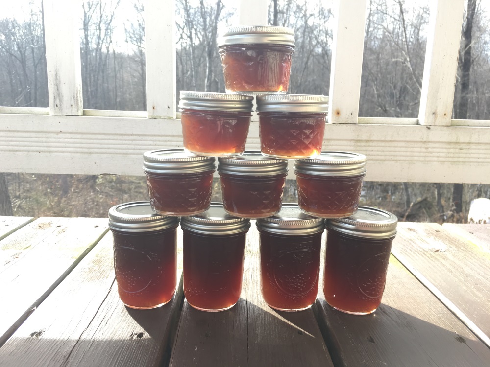 A pyramid of glass canning jars filled with pure maple syrup.